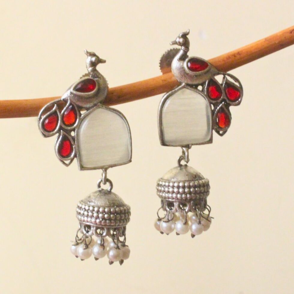 Elevate your ethnic look with antique silver peacock jhumka earrings.